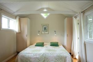 a bedroom with a bed and two windows at Pensionat Lövängen, Ljugarn in Ljugarn +54 photos