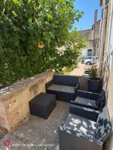 a group of chairs and tables on a patio at Les Trésors de Givry in Givry