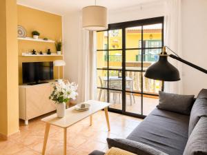 a living room with a couch and a table at Holiday in Playa Calera - Swimming pool in Valle Gran Rey