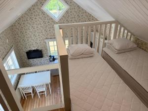 an overhead view of a bedroom with two beds and a table at Pensionat Lövängen, Ljugarn in Ljugarn
