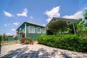 a small green house with a fence at Gabala Garden Harmony in Gabala
