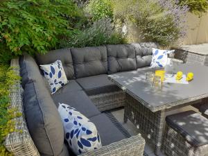 a patio with a couch and a table with pillows at Haus Mühlenbach in Mechernich