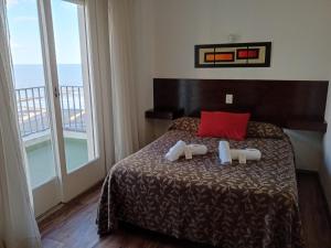 a bedroom with a bed and a large window at Hotel Rivoli in Mar del Plata +23 photos