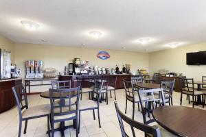 a restaurant with tables and chairs and a counter at Baymont by Wyndham Dale in Dale