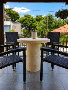 a table and chairs with a cup on top of it at Luxury casa in Nea Makri