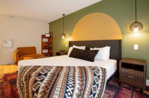 a bedroom with a bed and a chair in a room at Arroyo Pinion Hotel, an Ascend Collection Hotel in Sedona