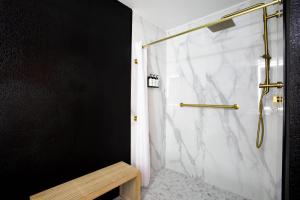 a bathroom with a shower with a marble wall at Arroyo Pinion Hotel, an Ascend Collection Hotel in Sedona