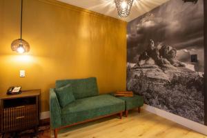a living room with a green chair and a painting at Arroyo Pinion Hotel, an Ascend Collection Hotel in Sedona +68 photos