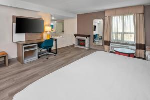 a hotel room with a bed and a fireplace at Comfort Inn in Mississauga