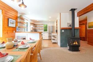 a kitchen with a table with a stove in it at Wandering Rivers Retreat in Glacier