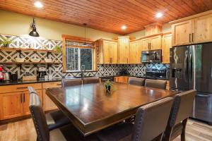 a kitchen with a large wooden table and chairs at Cottonwood Cabin in Glacier