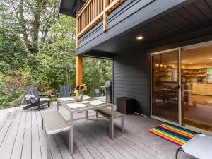 a patio with a table and chairs on a deck at Wandering Rivers Retreat in Glacier