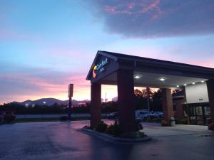 a mobil gas station with a sunset in the background at Comfort Inn near Downtown & Blue Ridge PKWY in Marion