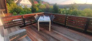 a table on top of a deck with a view at Das Tor zur Rhön in Dietlas