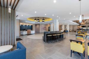a restaurant with a lobby with tables and chairs at Cambria Hotel Mount Pleasant - Charleston in Charleston