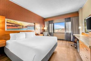 a hotel room with a large bed and a television at Radisson Hotel La Crosse in La Crosse