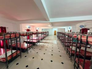 a room filled with lots of bunk beds at ABS Residency, Wayanad- Sulthan Bathery in Sultan Bathery