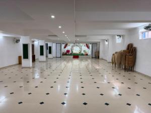 a large room with a white and black tile floor at ABS Residency, Wayanad- Sulthan Bathery in Sultan Bathery