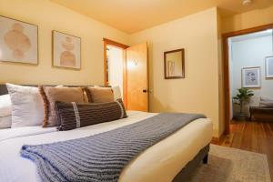 a bedroom with a large bed with pillows on it at Heliotrope Haus in Glacier