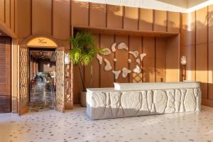 a lobby of a hotel with a reception desk at Ka Laʻi Waikiki Beach, LXR Hotels & Resorts in Honolulu +210 photos