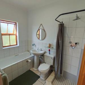 a bathroom with a toilet and a tub and a sink at Zion's Rest in Barrydale +52 photos