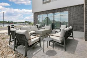 a group of chairs and tables on a patio at Home2 Suites By Hilton Somerset, Ky in Somerset