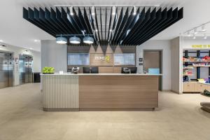 a lobby of a store with a counter and lights at Home2 Suites By Hilton Somerset, Ky in Somerset +29 photos