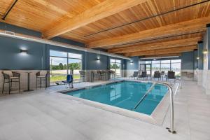 a swimming pool with a table and chairs in a building at Home2 Suites By Hilton Somerset, Ky in Somerset