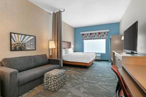 a hotel room with a couch and a bed at Home2 Suites By Hilton Somerset, Ky in Somerset