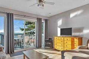 a living room with a couch and a tv at Isaiah Tubbs Resort & Conference Centre in Picton