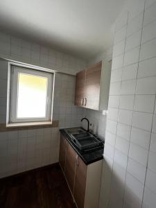 a small kitchen with a stove and a window at Apartmani Nika in Neum +19 photos