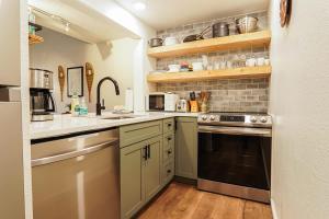 a kitchen with a sink and a stove at Riversong Retreat in Glacier