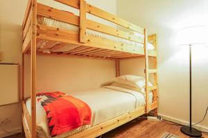 a bedroom with two bunk beds and a lamp at Riversong Retreat in Glacier