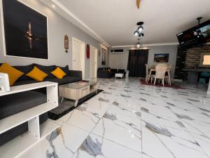 a living room with a couch and a fireplace at Nubian Villa with Private Pool in Naj‘ al Aḩwāl