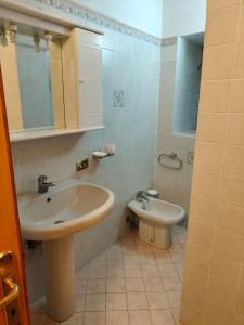 a bathroom with a sink and a toilet at Casa MEME' in Santa Maria Maggiore