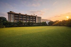 a building with a large lawn in front of it at Park Selections in Bhubaneshwar