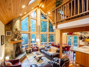a living room with a couch and a fireplace at Snowline Grand Lodge in Glacier