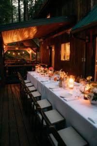 a long white table with chairs and candles at Snowline Grand Lodge in Glacier