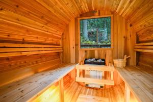 a wooden interior of a sauna with a window at Snowline Grand Lodge in Glacier