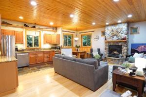 a living room with a couch and a fireplace at Snowline Hillside Chalet in Glacier