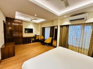 a hotel room with a bed and a desk at Park Selections in Bhubaneshwar