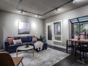 a living room with a blue couch and a table at Snowater Respite in Glacier