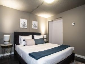 a bedroom with a large bed with white sheets at Snowater Respite in Glacier