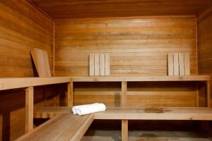 a sauna with wooden walls and wooden shelves at Snowater Respite in Glacier