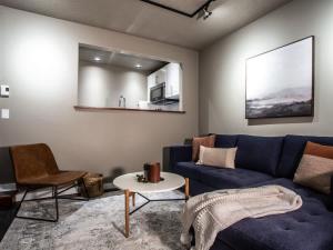 a living room with a blue couch and a table at Snowater Respite in Glacier +21 photos