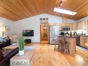 a living room with a couch and a kitchen at Woodland Bungalow in Glacier