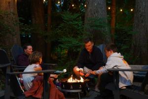a group of people sitting around a fire pit at Yverin Muse Cabin in Glacier