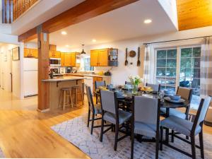 a kitchen and dining room with a table and chairs at Yverin Muse Cabin in Glacier