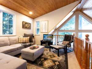 a living room with a couch and a table at Yverin Muse Cabin in Glacier