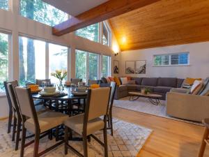 a dining room and living room with a table and chairs at Yverin Muse Cabin in Glacier